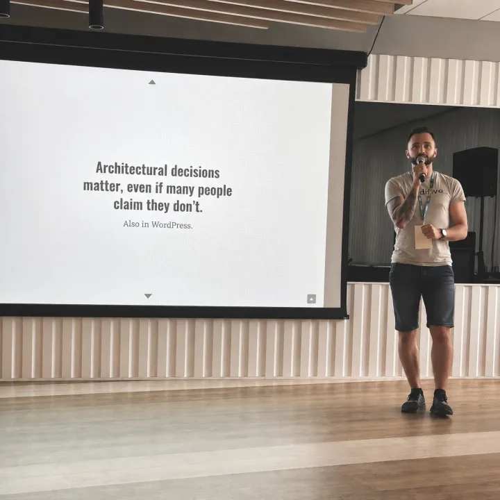 Przemek presenting on stage at a WordCamp conference